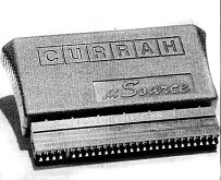 The Currah micro-Source is a small black plastic wedge shaped device which plugs into the back of the ZX Spectrum's expansion port.