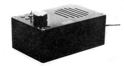 The Zeal Sound Booster is housed in black plastic project box with a grille for the speaker and one control knob underneath the grille. On the left of the control know is a switch. An lead protrudes from the rear of the unit.