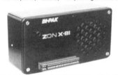 The ZON-X 81 is housed in a black plastic project box with an edge connector at the bottom and an open grille for the speaker on the right of the unit.